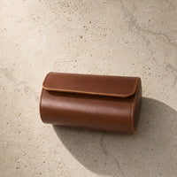 Brown leather watch travel case open with watch, lifestyle shot