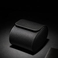 Black leather watch travel case in use, lifestyle shot