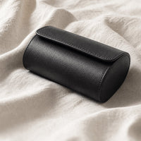 Black leather watch travel case open with watch, lifestyle shot